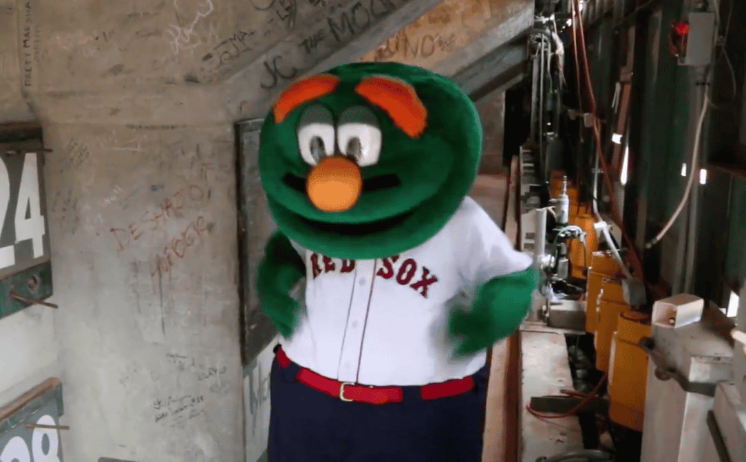 A vibrant image of Wally the Green Monster, Fenway Park's beloved mascot, entertaining fans during a game.
